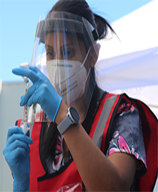 Image of a health care worker preparing a vaccine