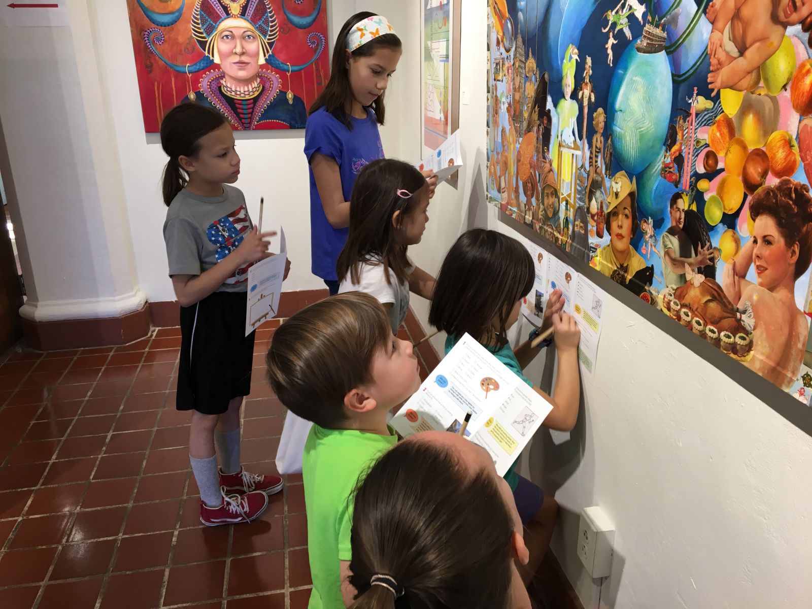 A photo of children studying a painting at Marin MOCA Family Art Day