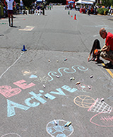 Image of child writing with chalk on the street