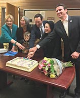 Photo of Novato Council cutting cake